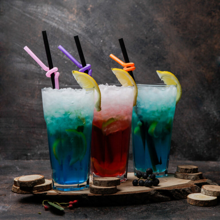 close-up-alcohol-cocktails-glasses-blue-lagoon-cocktail-decorated-with-lemon-glass-cocktail-with-whiskey-wooden-stand